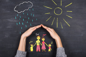 hands protects family from the elements - rain or storm
