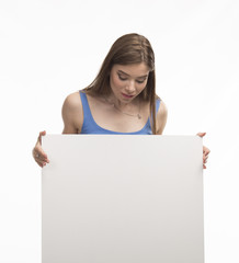 Fototapeta premium Young happy woman showing presentation, pointing on placard over