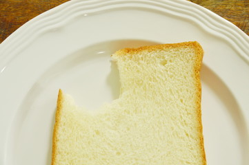 slice bread bite on white plate