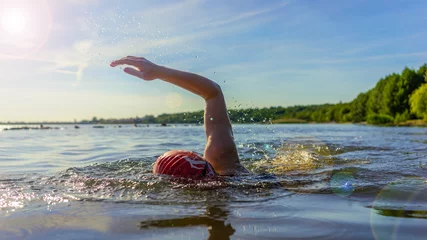 Fotobehang Woman swimming in a lake © DZiegler