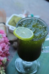 Iced green tea with lemon and matcha tea powder.