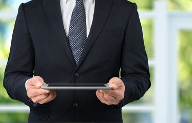 Businessman working on digital tablet.