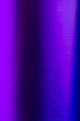 Detailed view of a blue metallic can with light reflections and color hue