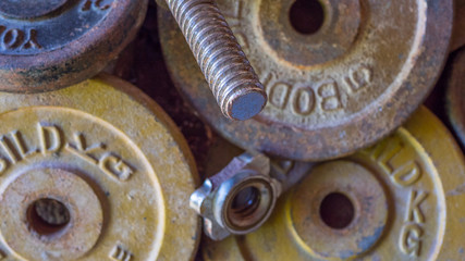 Rusty old Weights slowly rust left abandoned on the floor