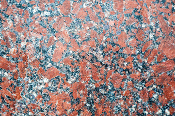 A marble background with small spots of red, black and white colors