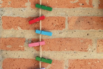 Clothes peg colorful clamps on the rope.