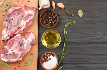 fresh raw meat with spices on wooden table. top view with copy space