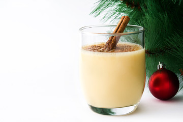 Obraz na płótnie Canvas Homemade eggnog with cinnamon isolated on white background. Typical Christmas dessert.