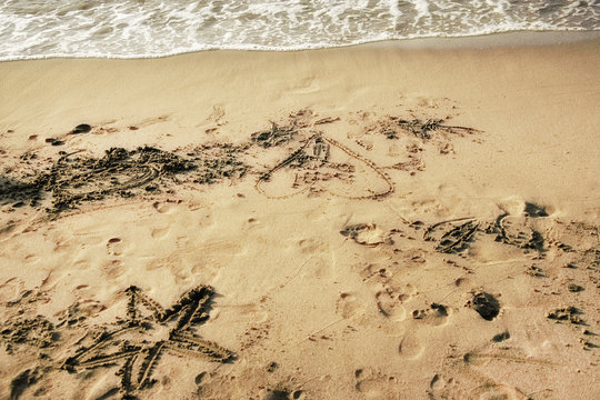 drawings on sandy beach