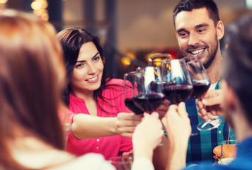 friends clinking glasses of wine at restaurant