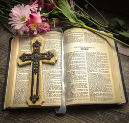 Bible And Cross Background. Fresh flowers and a crucifix with an open King James Bible.