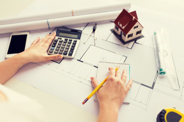 close up of architect hand counting on calculator