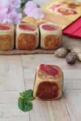 Festival moon cake with red envelopes, Chinese New Year.