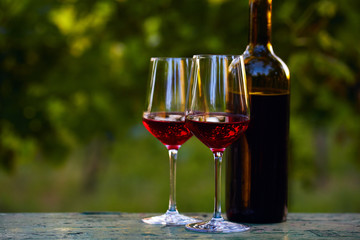 Two glasses of red wine and bottle
