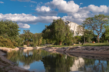 Fototapeta na wymiar Valencia, Spain Gardens in the old dry riverbed of the Turia river, water reflection. Beautiful landscape leisure and sport area with trees, grass and water mirror