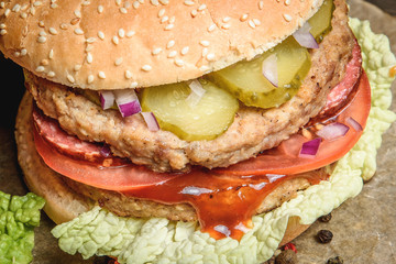 Burger with salami and vegetables