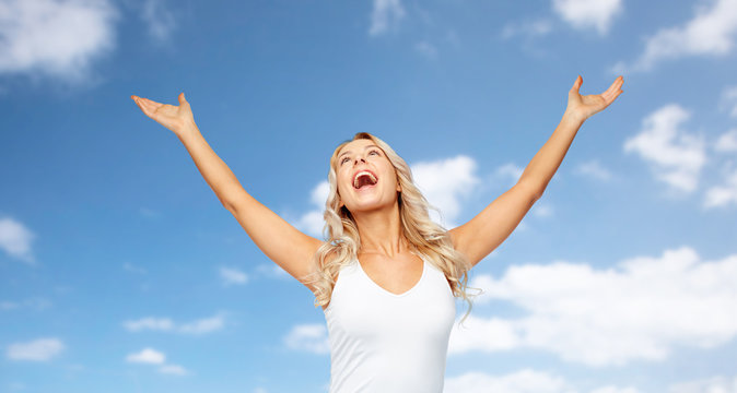 happy woman celebrating victory over blue sky