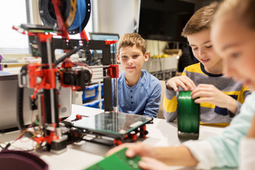 happy children with 3d printer at robotics school