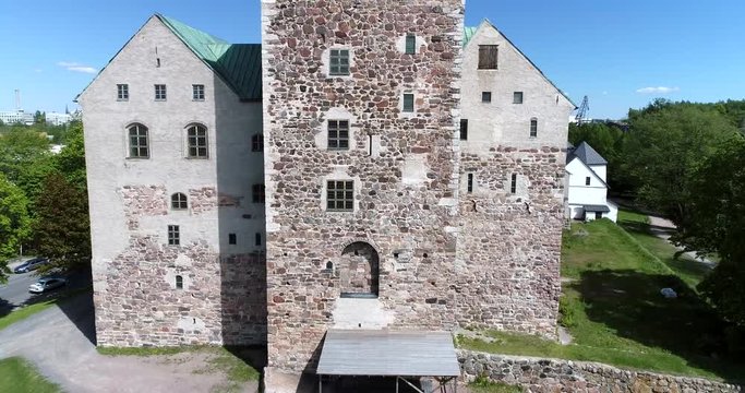 Turku castle, Cinema 4k aerial rising view over turun linna and revealing turku cityscape, on a sunny summer day, in Abo, Finland