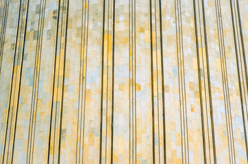 Texture of shell rock, marble. With relief strips on the building.