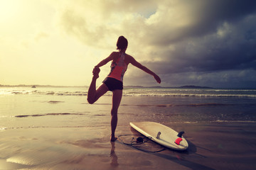 Young woman surfer wit surfboard ready to surf