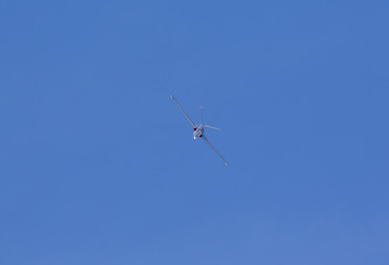 Fouga Magister vintage airplane flying against a blue sky.