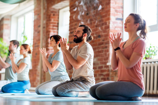 group of people meditating at yoga studio