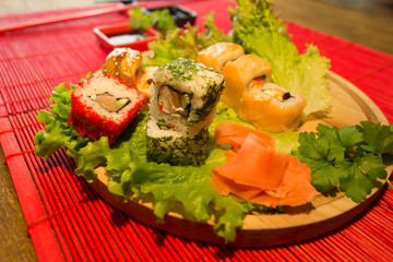 Beautifully decorated sushi on a plate and chopsticks are near it