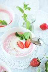 Cold creamy strawberry soup with a scoop of ice cream and mint
