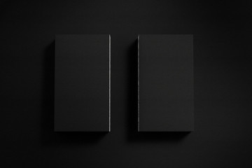 Mockup of two business cards on black textured paper studio. High resolution 3d render.