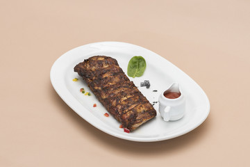  Grilled rib pork with barbecue sauce, placed on white plate, light background, isolated