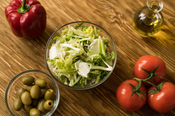 Salad ingridients. Tomato, lettuce, paprika and olive oil.