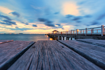 wood bridge to the sea at sunset.
