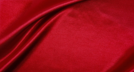 Smooth elegant red silk or satin luxury cloth texture as abstract background. Luxurious background design
