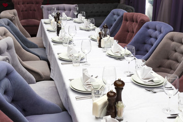 A table with dishes and chairs near the table 