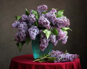 .Bouquet of purple lilac in a blue vase.