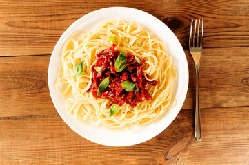 Italian dish - pasta with sundried tomato and basil. Top view