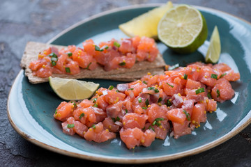 Close-up of salmon tartare, selective focus, shallow depth of field, studio shot