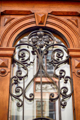 Wooden doors with wrought iron grating and glass
