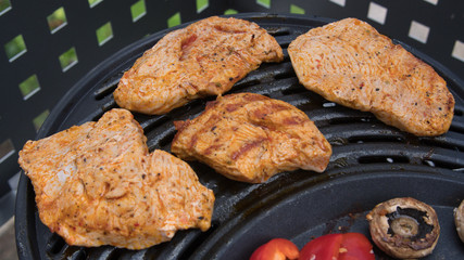 meat, pepper, mushrooms and sausages on the BBQ.