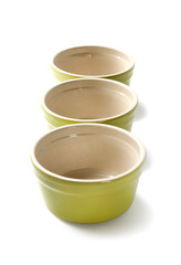 Glazed ceramic pots for cooking on a white background