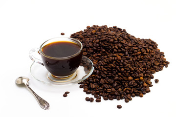 Grains of coffee and a cup of black coffee on a white background, studio light