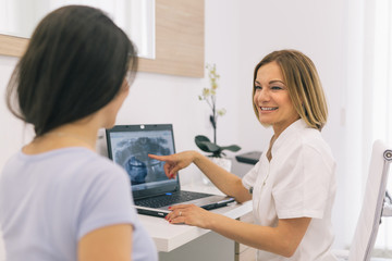 At the dentist. Doctor and patient talking about keeping the healthy teeth