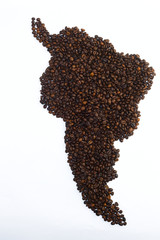 Grains of coffee in the form of mainland South America on a white background, studio light