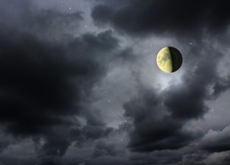 Naklejka na ściany i meble Moon glowing in the dark night sky