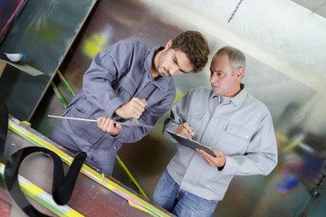 engineer and manager working in mechanic storage room