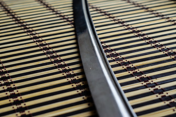 Japanese sword katana on bamboo mat