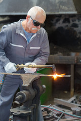 senior metal worker welding joint steel