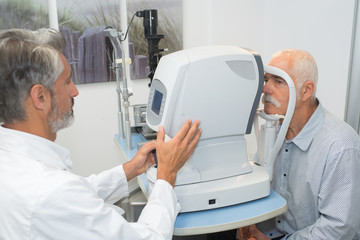 optometrist doing sight testing for patient in clinic