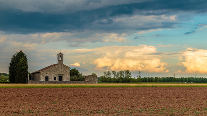 Storm reaching a little church in the fields